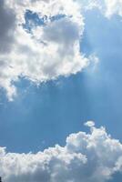 A Blue Sky of Fluffy Clouds and Sunlight photo