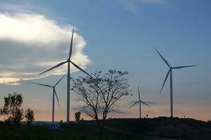 Wind turbines at sunset with a beautiful sky in the background. The concept of renewable energy. photo