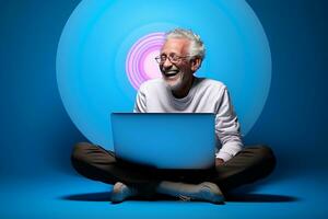 old man is sitting with a laptop photo