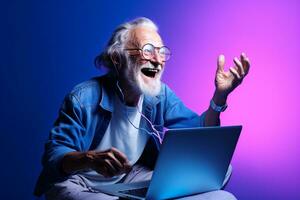 old man is sitting with a laptop photo