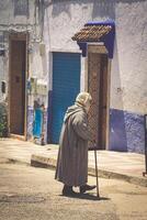 typical man in morocco in a typical street going up stairs photo