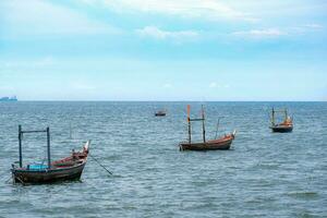 Fishing boats used to catch fish Located on sea water with slight waves. Used to find food for people who earn a living catching fish. For those who live next to the sea photo