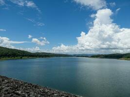 The large reservoir of the earth dam for hydroelectric power generation. photo