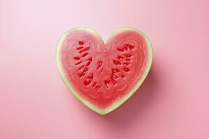 Fresh watermelon slice in heart shape on pink background, top view. photo