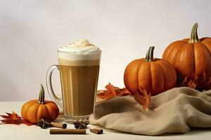 Pumpkin latte with whipped cream, cinnamon and autumn leaves. photo