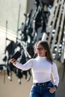 Female tourist taking selfies at the Vargas Swamp Lancers memorial located near Paipa city in Boyaca. Realized by Colombian artist Rodrigo Arenas Betancourt and by engineer Guillermo Gonzalez Zuleta. photo