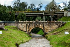 Historic Bridge over the Teatinos River in Colombia located next to the Boyaca Bridge photo