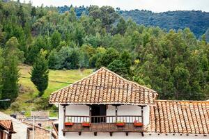View of the beautiful mountains and houses of the small town of Tibasosa in the region of Boyaca in Colombia photo