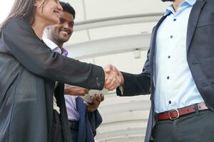 two business people shaking hands to greet each other photo