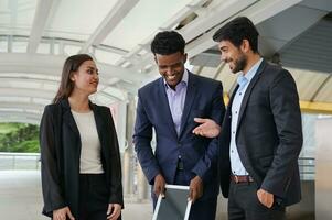 multiracial business people chatting happily during break while work outside, concept good working relationship, good relationship at work photo