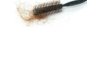 Hair loss in comb, hair fall everyday serious problem, on white background. photo