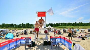 Swinoujscie, Poland. 15 August 2023. Lifeguards with rescue tower on the beach of the Baltic Sea photo