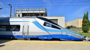 Warsaw, Poland. 5 September 2023. PKP Intercity Polish train sleeping car at station platform awaiting departure in late afternoon. PKP intercity Pendolino train. photo