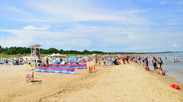 Swinoujscie, Poland. 15 August 2023. People relax on the crowded beach of the Baltic Sea on the island of Usedom. photo