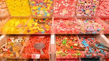 Plastic jars filled with colourful candy in shop. photo