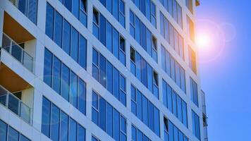 Exterior of a high modern multi-story apartment building - facade, windows and balconies. photo