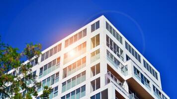 Exterior of a high modern multi-story apartment building - facade, windows and balconies. photo