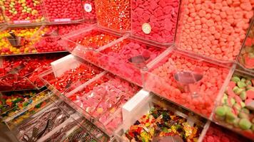 Plastic jars filled with colourful candy in shop. photo