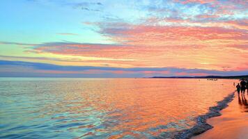 A summer sunset scenery on the horizon. Sea in golden colors and amazing clouds on sky. photo