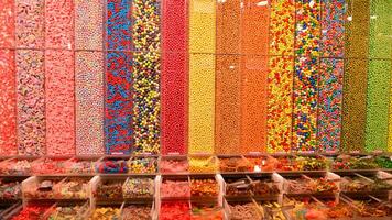 Plastic jars filled with colourful candy in shop. photo