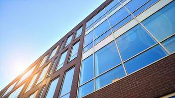 Architecture details. Modern glass building facade in sunny day. Business background. photo