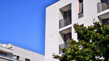 Green community. Eco apartment building saving energy and fresh air concept. Block of flats in beautiful green public photo