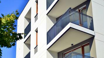 Green community. Eco apartment building saving energy and fresh air concept. Block of flats in beautiful green public photo
