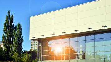 Minimalist photo of an exterior of a modern tin building with big glass showcases.