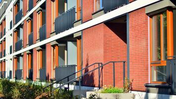 Green community. Eco apartment building saving energy and fresh air concept. Block of flats in beautiful green public photo