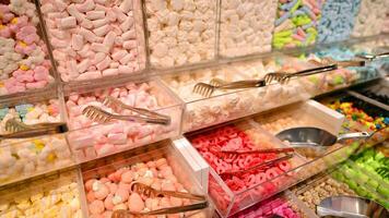 Plastic jars filled with colourful candy in shop. photo