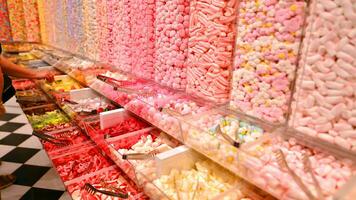 Plastic jars filled with colourful candy in shop. photo