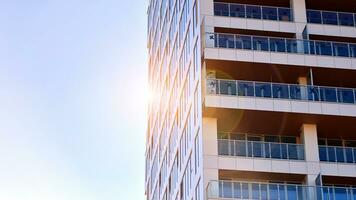 Exterior of a high modern multi-story apartment building - facade, windows and balconies. photo