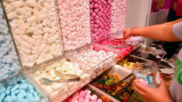 Plastic jars filled with colourful candy in shop. photo