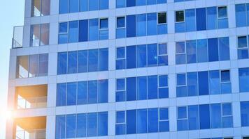 Exterior of a high modern multi-story apartment building - facade, windows and balconies. photo