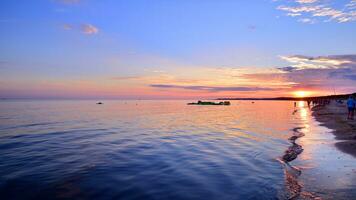 A summer sunset scenery on the horizon. Sea in golden colors and amazing clouds on sky. photo