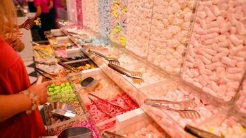 Plastic jars filled with colourful candy in shop. photo