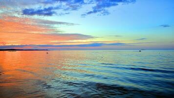 A summer sunset scenery on the horizon. Sea in golden colors and amazing clouds on sky. photo
