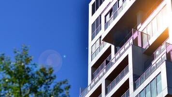 Exterior of a high modern multi-story apartment building - facade, windows and balconies. photo