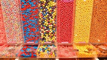 Plastic jars filled with colourful candy in shop. photo