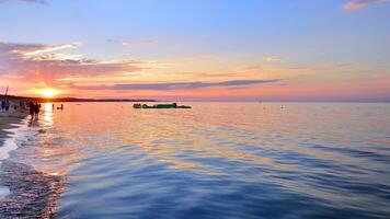 A summer sunset scenery on the horizon. Sea in golden colors and amazing clouds on sky. photo