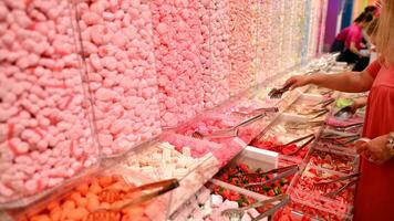 Plastic jars filled with colourful candy in shop. photo