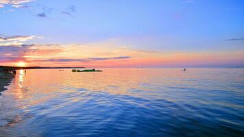 A summer sunset scenery on the horizon. Sea in golden colors and amazing clouds on sky. photo