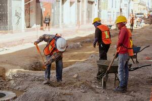 Puebla, Mexico 2023 - Construction workers work to repair a street in the Historic Center of Puebla photo