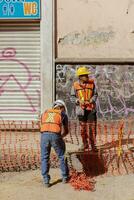 Puebla, Mexico 2023 - Construction workers work to repair a street in the Historic Center of Puebla photo