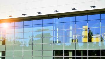 Minimalist photo of an exterior of a modern tin building with big glass showcases.