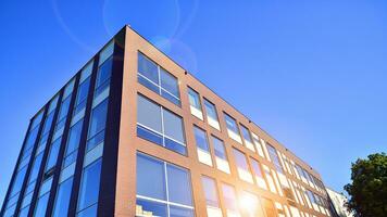 Architecture details. Modern glass building facade in sunny day. Business background. photo