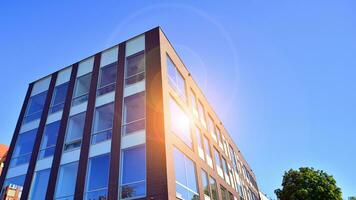 Architecture details. Modern glass building facade in sunny day. Business background. photo