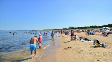 Swinoujscie, Poland. 15 August 2023. People relax on the crowded beach of the Baltic Sea on the island of Usedom. photo