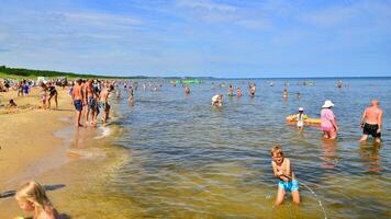 Swinoujscie, Poland. 15 August 2023. People relax on the crowded beach of the Baltic Sea on the island of Usedom. photo