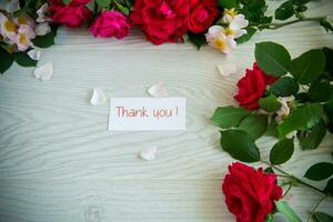 background of many red roses on a light wooden photo